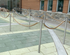 Stainless steel loop posts with rope forming an outdoor guest pathway at a zoo